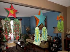 christmas decorations hang from the ceiling in a living room