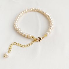 "Natural freshwater pearl bracelet, dainty adjustable bracelet is finished off with paperclip 14k gold fill extender chain and lobster clasp. A elegant gift for her. DETAILS * Genuine Freshwater Pearls * June Birthstone * 4mm Freshwater Pearl beads * Bracelet measures approx. 6.5inch (16.5 cm) in length. * 14k gold fill extender chain and gold filled clasp * Chain and findings are nickel free BRACELET SIZE * Available sizes - 6.5 inches, plus 1 inch paperclip extender chain HOW TO SIZE BRACELET Dainty Adjustable Single Strand Pearl Bracelet, Dainty Adjustable Beaded Bracelets With Pearl Chain, Dainty Adjustable Pearl Chain Bracelet, Dainty Adjustable Pearl Bracelet, Adjustable Hypoallergenic Pearl Bracelet For Mother's Day, Adjustable Pearl Bracelet For Anniversary, Adjustable Pearl Drop Bracelet As Gift, Adjustable Pearl Drop Bracelet For Gift, Adjustable Pearl Bracelets For Mother's Day