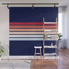 a room with a blue wall and wooden flooring that has stripes painted on it