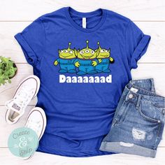 a blue tshirt with three cartoon characters on it and the words daaaaand