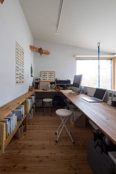 an office with wooden floors and white walls