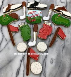 decorated cookies are arranged in the shape of golf related items