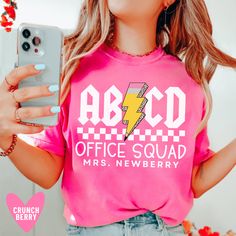 This custom office squad shirt is retro, trendy, and fun! The perfect teacher gift:) Our Bella+Canvas tees have that light and vintage feel. ♥ Our Comfort Colors tees are garment-dyed for that trendy distressed look. ♥ 》 》HOW TO ORDER 《 《 * Select product, size + color from the drop down menus * Add to cart + place order ♥ * Your shirt is now in production & will be ready to ship in 1-3 days! 》 》SIZING 《 《 These tees are unisex, men's cut tops. The Bella Canvas tees run longer than normal and slightly small - so I would NOT downsize. The Comfort Colors tees and long sleeves are boxy cut and true to size. 》 》PRODUCTION + SHIPPING《 《 * Order Production: 1-3 business days  * Standard Shipping: 2-5 business days after production time 》 》 ANATOMY OF OUR SHIRTS 《 《 * Bella Canvas 3001 * Airlume Cheap Screen Print Shirt For School, School Staff Shirt Ideas, Office Squad Shirt, Funny College Short Sleeve T-shirt, Funny College T-shirt With Short Sleeves, Retro School T-shirt With Text Print, Retro Text Print T-shirt For School, Trendy School T-shirt With Funny Print, Retro Letter Print T-shirt For School