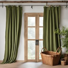 a green curtain in front of a window with a basket and potted plant next to it