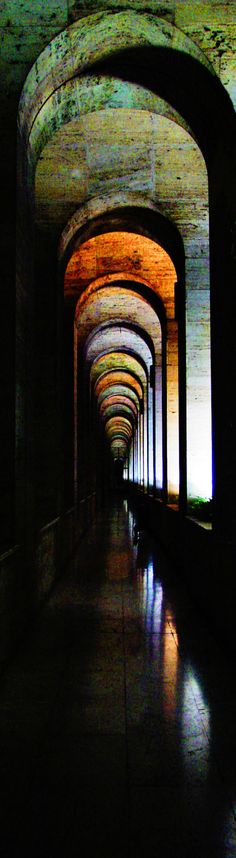 the tunnel is lined with arches and lights