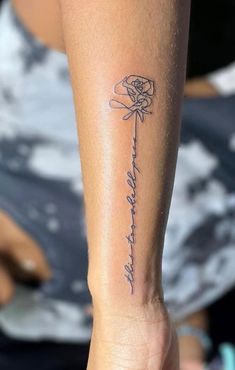 a woman with a tattoo on her arm holding a rose and the words, i love you