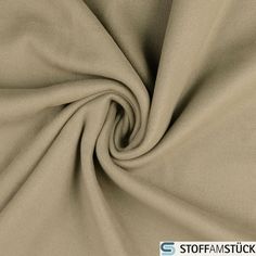 a close up shot of a tan colored fabric with the word stop and tuck on it