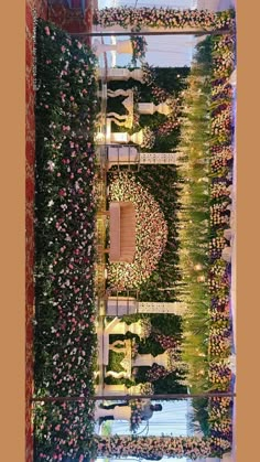 an overhead view of a wedding ceremony with flowers and greenery