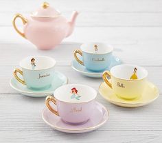 four disney princess tea cups and saucers on a white wooden table with the name ariel