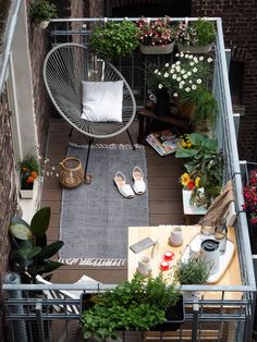 an overhead view of a balcony with potted plants and shoes on the floor,