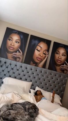 a woman laying on top of a bed next to three pictures hanging above her head