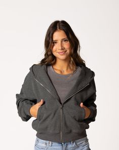 The Favorite Cropped Zip-Up is THE piece you need — immediately. The fabric and fit of this piece are what makes it a true winner. The outward-facing side is buttery soft to the touch, while the inside is soft, cozy fleece that only gets better with wear and time. Grab it on the go whenever you need a layering piece that can keep up with you all day long. FIT & FABRIC: Made from soft and cozy mid-weight cotton/span jersey fleece. Relaxed, cropped fit that hits at the waist. Front zip for easy la Crop Zip Up Hoodie Outfit, Crop Zip Up Hoodie, Dark Grey Hoodie, Cropped Zip Up Hoodie, Classic Corvette, Dream List, Cropped Zip Up, Stockholm Fashion, Low Impact Workout