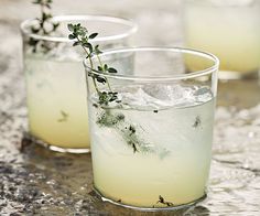 three glasses filled with drinks sitting on top of a table