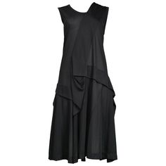 Junya Watanabe for Comme des Garcons black rayon abstract tank dress featuring various pleating throughout. Spring/Summer 1996 Collection. Excellent Condition Size: Small Measurements: Bust 33" Waist 34" Hips 39" Black Silk Sleeveless Summer Dress, Black Pleated Asymmetrical Dress, Black Asymmetrical Silk Midi Dress, Black Sleeveless Silk Dress For Spring, Sleeveless Black Silk Dress For Spring, Black Linen Shirt, Informal Dress, Skirt Collection, Comme Des Garcons Black