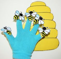 a blue glove with yellow and black bees on it