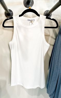 Back to the basics as we welcome our Crew Neck Tank Top in White! It's a ribbed style, perfect for layering with a kimono or cardigan. This tank top includes a scoop neck and can be a little more see thru depending on your color choices. These are paired with our adorable cargo pants! We offer black or khaki! **Photo is shown paired with the color khaki** ABOUT THIS ITEM: Made in China. Fabric is 60% Cotton / 40% Rayon. Machine wash cold. Tumble on low or hang dry. The Model is 5'5, and is wearing a size small. Maxi Tops, Jumpsuit Shorts Rompers, Tunic Sweater, Sleeveless Sweater, Loungewear Sets, Color Khaki, Cargo Pants, Long Tops, Jumpsuit Romper