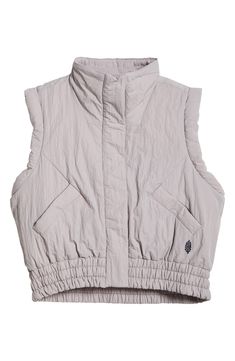 Stay warm and be cool in this lightly puffed vest made from moisture-wicking, water-resistant fabric. 22 1/2" length (size Medium) Front snap closure Stand collar Front snap-welt pockets Elastic waist Moisture-wicking fabric engineered for dryness and comfort Water-resistant Lined, with 100% recycled-polyester fill 100% recycled nylon Machine wash, tumble dry Imported Spring Nylon Puffer Vest, Spring Outdoor Nylon Vest, Sporty Spring Vest For Outdoor Activities, Sporty Sleeveless Puffer Vest, Spring Nylon Stretch Vest, Spring Season Stretch Nylon Vest, Puff Vest, Be Cool, Fp Movement