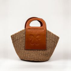 Shopping Beach Bag With Braided Top Handles, Shopping Beach Bag With Top Handle And Braided Handles, Top Handle Beach Bag With Braided Handles For Shopping, Casual Woven Top Handle Bag, Casual Straw Bag With Top Handle For Shopping, Casual Top Handle Straw Shopping Bag, Top Handle Straw Bag For Shopping, Light Brown Woven Bags For Vacation, Light Brown Woven Vacation Bag