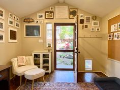 a living room with pictures on the wall and a door leading to a patio area