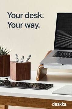 a laptop computer sitting on top of a wooden desk next to a keyboard and mouse