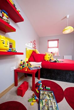 a child's bedroom decorated in legos and red carpeted flooring, with shelves on the wall