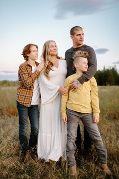 a family posing for a photo in a field