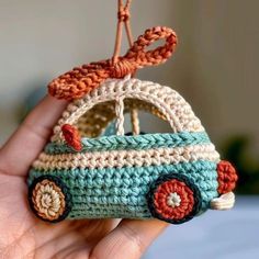 a small crocheted car ornament in the shape of a handbag