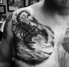 a black and white photo of a man with a scorpion tattoo on his chest,