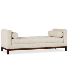 an upholstered chaise lounge with pillows on it