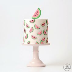 a white cake with watermelon slices on it and the words tokikannuka written in russian