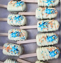 there are many marshmallows that have been decorated with blue and orange designs