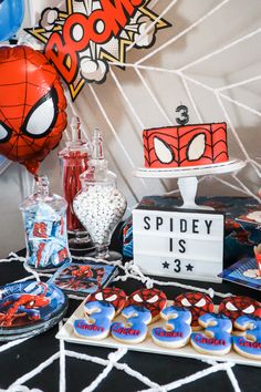 a spiderman themed birthday party with cookies and desserts