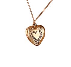 Vintage 1940s gold filled heart locket with etched heart and floral engraved.  The locket opens with ease and closes with a strong snap.  The locket is marked P&K on the inner frame.  This would make a fantastic addition to any jewelry collection. Locket measures 7/8" X 3/4" from the top of its original bale. Weight: 3.85 grams A condition is excellent, with no damages or repairs. The business American Queen Pitman & Keeler was based in Attelboro, MA and they were in business from approximately American Queen, Engraved Flower, Heart Locket, Locket, Jewelry Necklace Pendant, Solid Gold, Gold Filled, Pendant Necklaces, Jewelry Collection