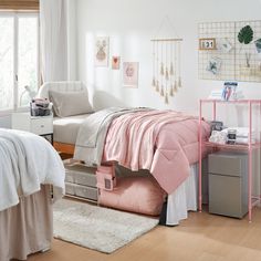 a bedroom with white walls and pink furniture