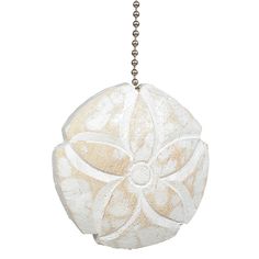 a white flower ornament hanging from a chain