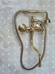 an old fashioned brass faucet on the wall