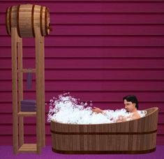 a man sitting in a bathtub filled with foam next to a pink wall and ladder