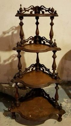 a three tiered wooden shelf sitting on top of a floor