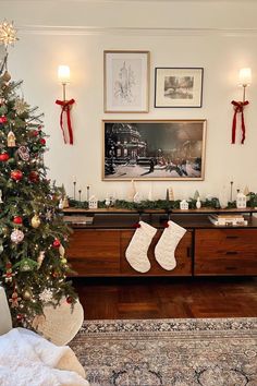 a living room with a christmas tree and pictures on the wall