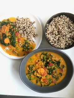 three bowls filled with different types of food on top of a white table next to rice