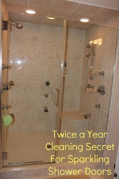 a shower with the words twice a year cleaning secret for sparkling shower doors