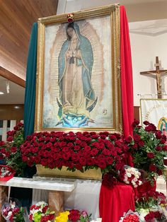 a painting and flowers on display in a church