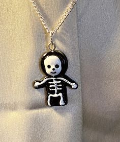 This is a really fun, kitsch piece of jewellery which is perfect for children and adults alike. The skeleton is a fun, minimal way to dress up any outfit at Halloween.  The necklace is easy and light to wear, making it a fun addition to your jewellery box.  The necklace can be made with either a silver or gold chain, making it perfect for your skin colour.  This piece of jewellery would make a lovely gift for anyone. Adjustable Necklaces For Halloween Costume Party, Spooky Black Necklace For Gift, White Gothic Necklace Gift, Halloween Novelty Necklaces As Gift, Halloween Nickel Free Pendant Necklace, Halloween Nickel-free Pendant Necklace, Novelty Halloween Party Necklaces, Nickel-free Halloween Party Necklace, Adjustable Halloween Necklace Gift