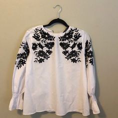 Zara White Long Sleeve Blouse With Black Velvet And Sequined Flowers Excellent Condition Smocked Detail On Wrists Two Little Buttons On The Back Never Worn White Embroidered Top For Work, White Embroidered Tops For Workwear, Zara Black Tops With Floral Embroidery, Zara Black Embroidered Tops, Zara Blouse With Floral Embroidery For Fall, Casual Embroidered Zara Blouse, Zara Embroidered Casual Blouse, Zara Casual Embroidered Blouse, Chic Embroidered Zara Tops