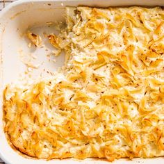 a casserole dish with cheese and onions in it