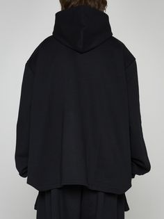 Random Identities' unisex black cotton hoodie featuring a fixed hood, elongated cut-out on front, wide sleeves with puffed cuffs and rounded hem on the back. Composition: 100% cotton Black Oversized Hoodie With Detachable Hood, Oversized Black Hoodie With Detachable Hood, Black Oversized Hooded Jacket With Detachable Hood, Oversized Black Hooded Jacket With Detachable Hood, Oversized Sweatshirt With Detachable Hood For Streetwear, Oversized Hoodie With Ribbed Cuffs And Funnel Neck, Oversized Hoodie With Double-lined Funnel Neck, Black Oversized Hoodie With Funnel Neck, Oversized Black Hoodie With Funnel Neck