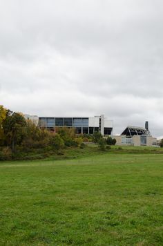 a large building sitting on top of a lush green field