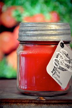 a jar filled with red liquid sitting on top of a wooden table