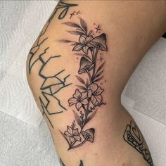 a woman's leg with flowers on it and the word happy written in black ink