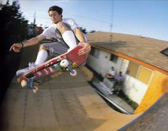 a man riding a skateboard up the side of a ramp